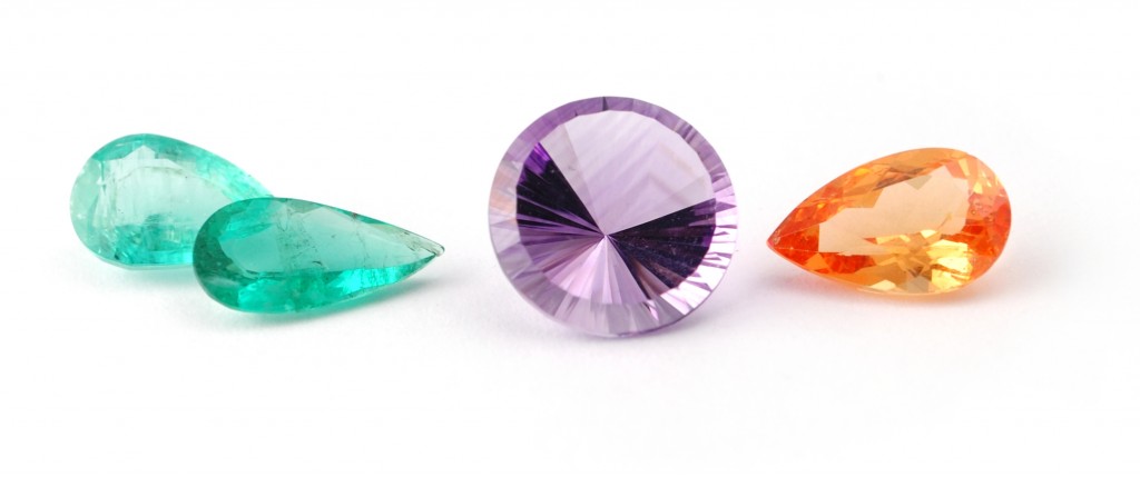 Emerald, amethyst and mandarin garnet faceted gemstones