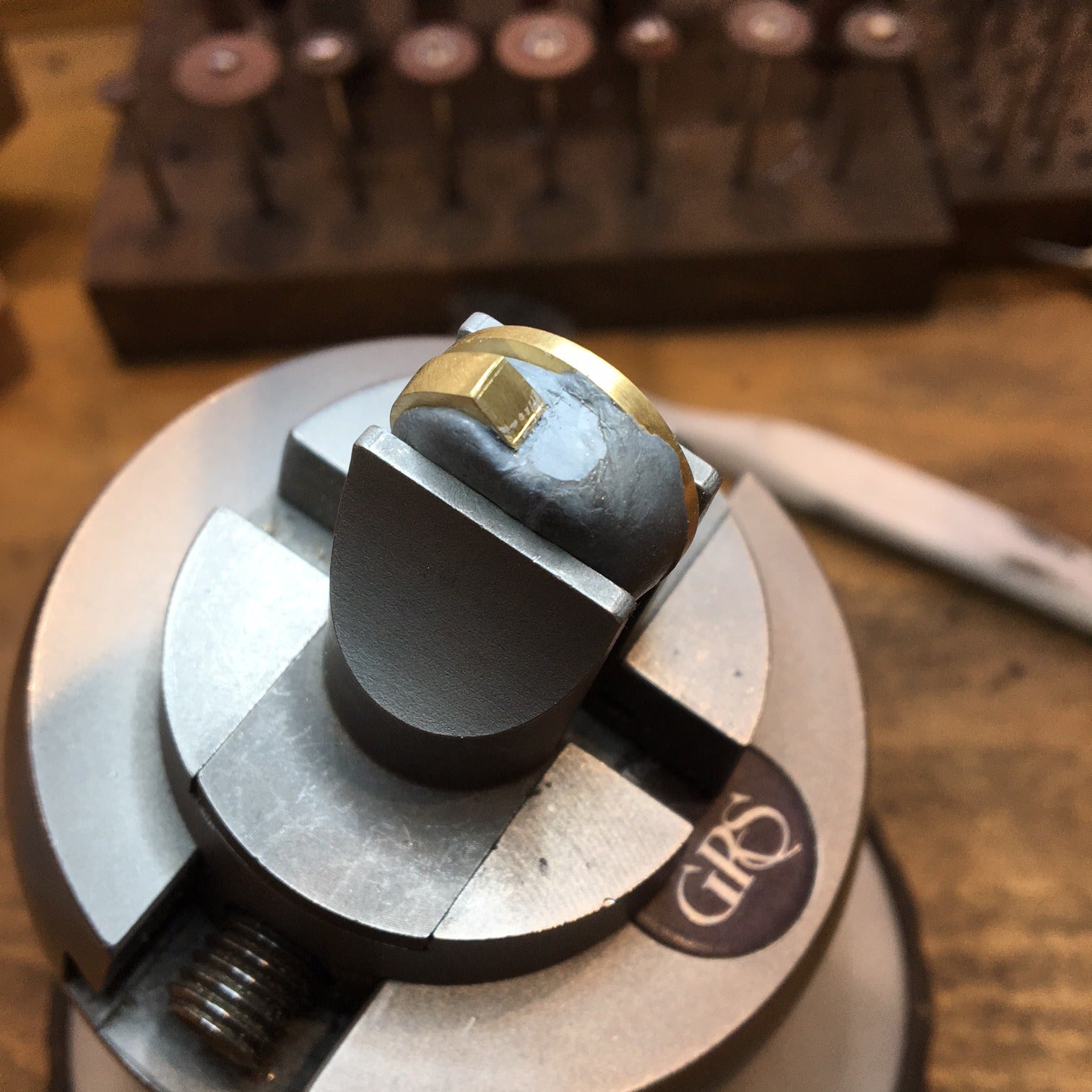 Forged gold ring being set with diamond