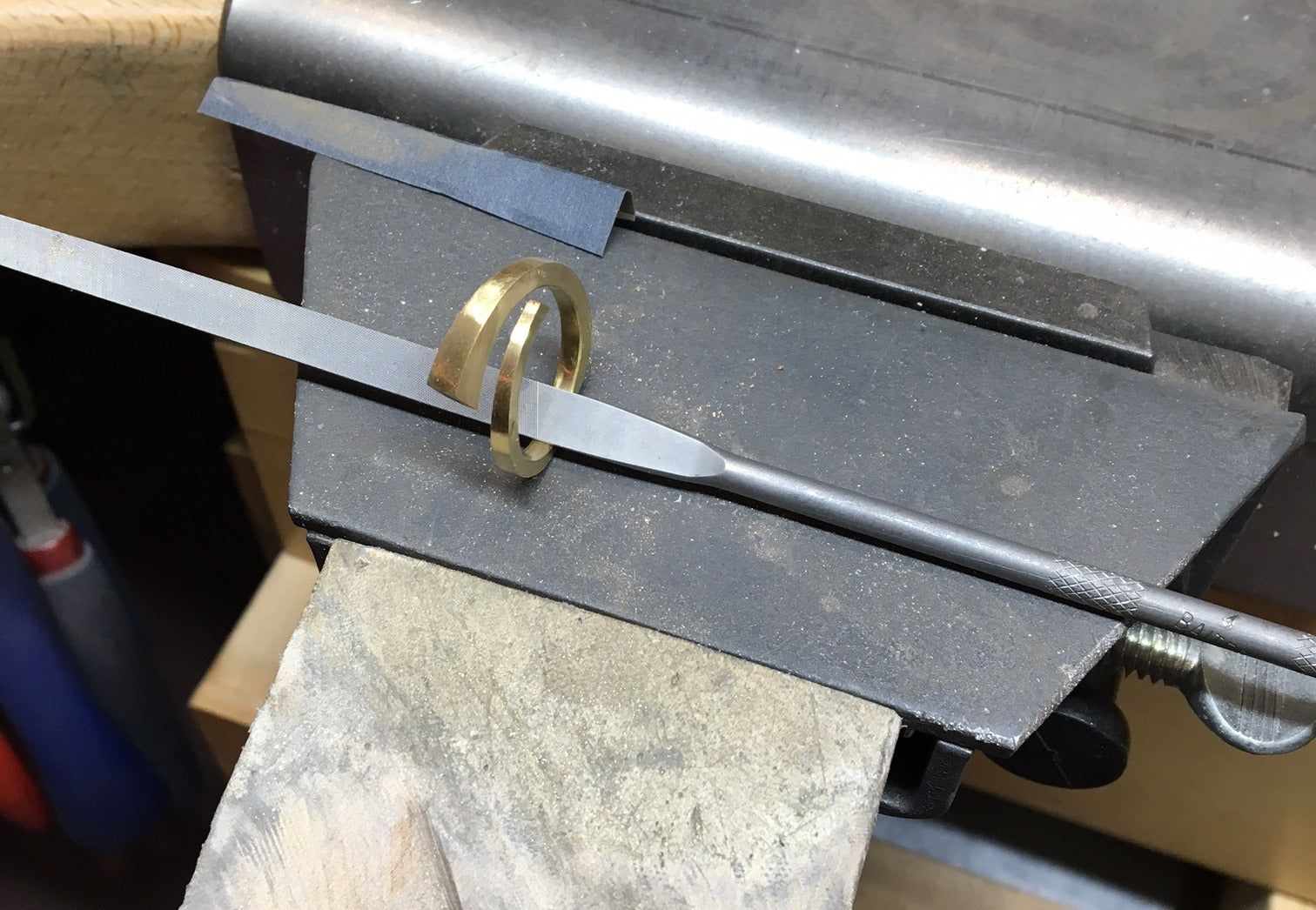 Forged yellow gold ring on workbench