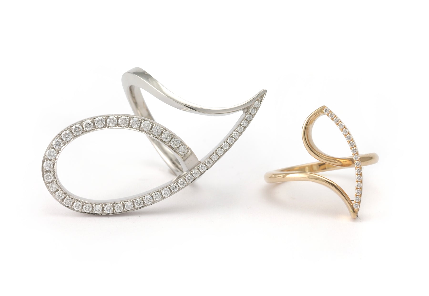 Forged platinum and white diamond cocktail ring next to a smaller gold ring