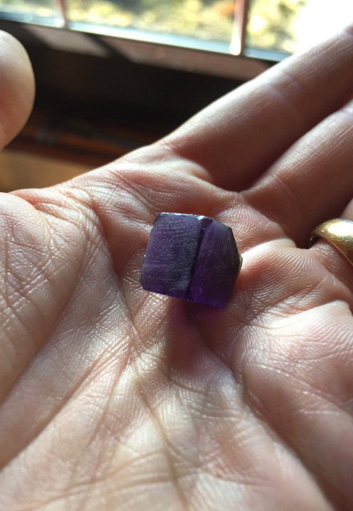 Rough amethyst gemstone crystal ready to cut