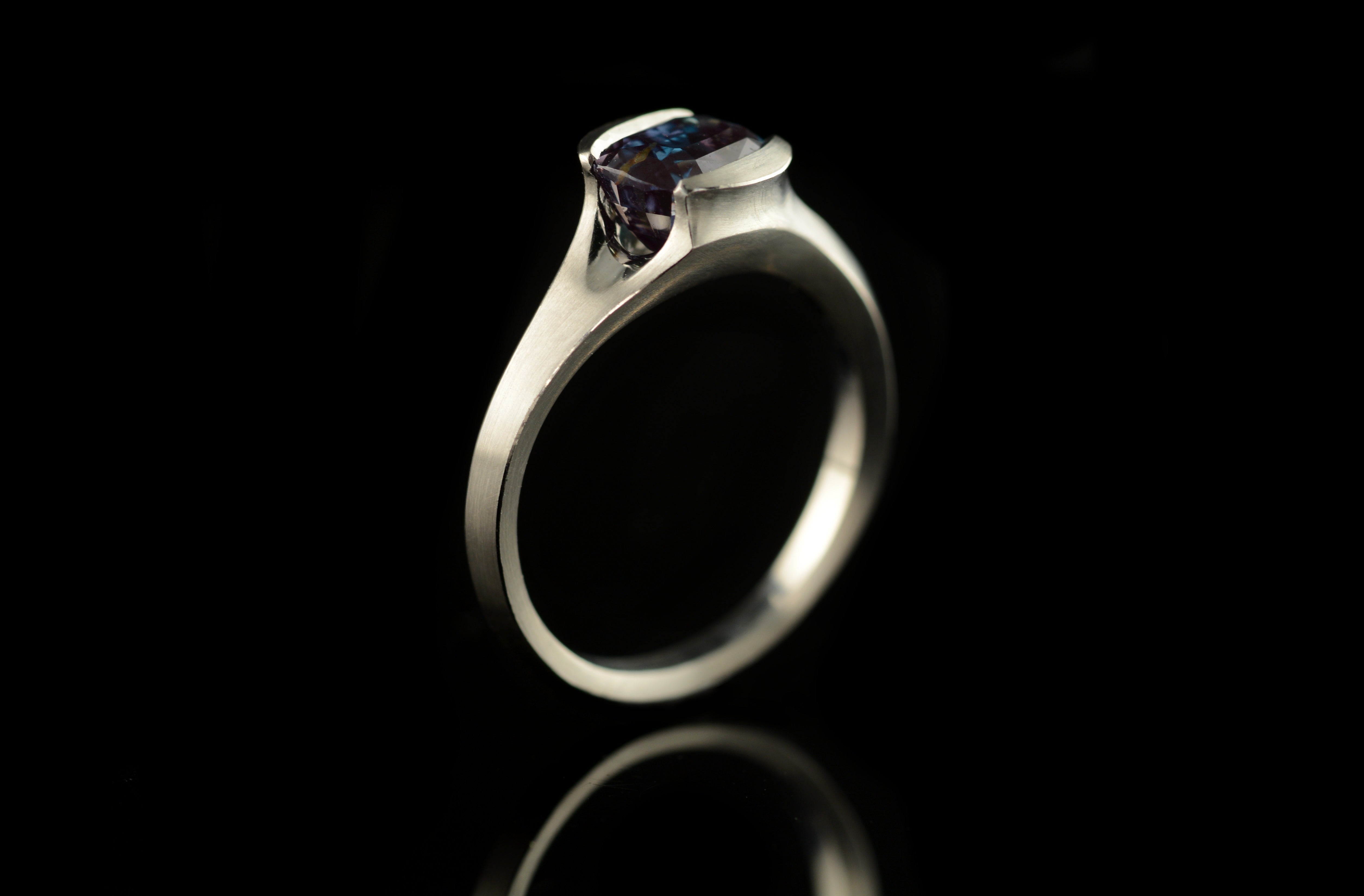Carved platinum and alexandrite colour-change engagement ring