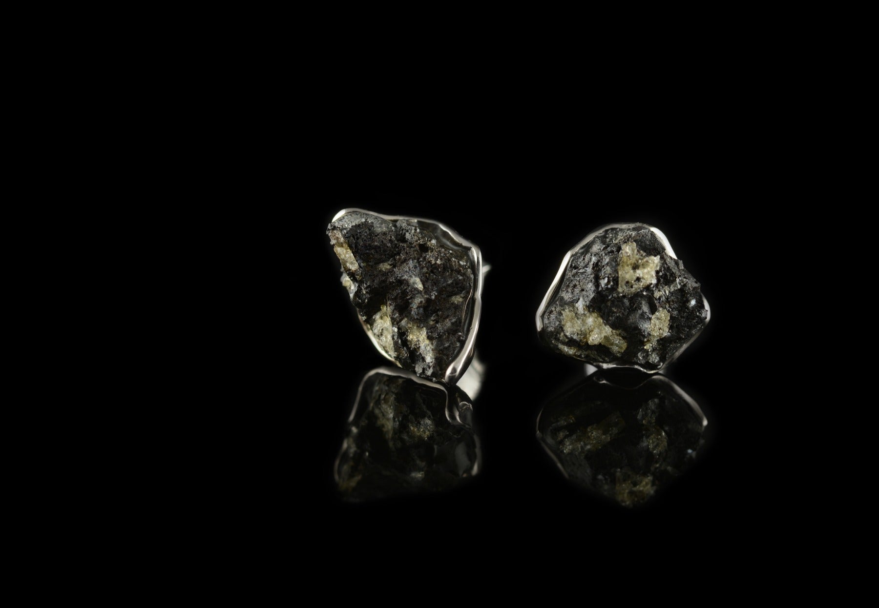 Bespoke white gold stud earrings set with volcanic lava