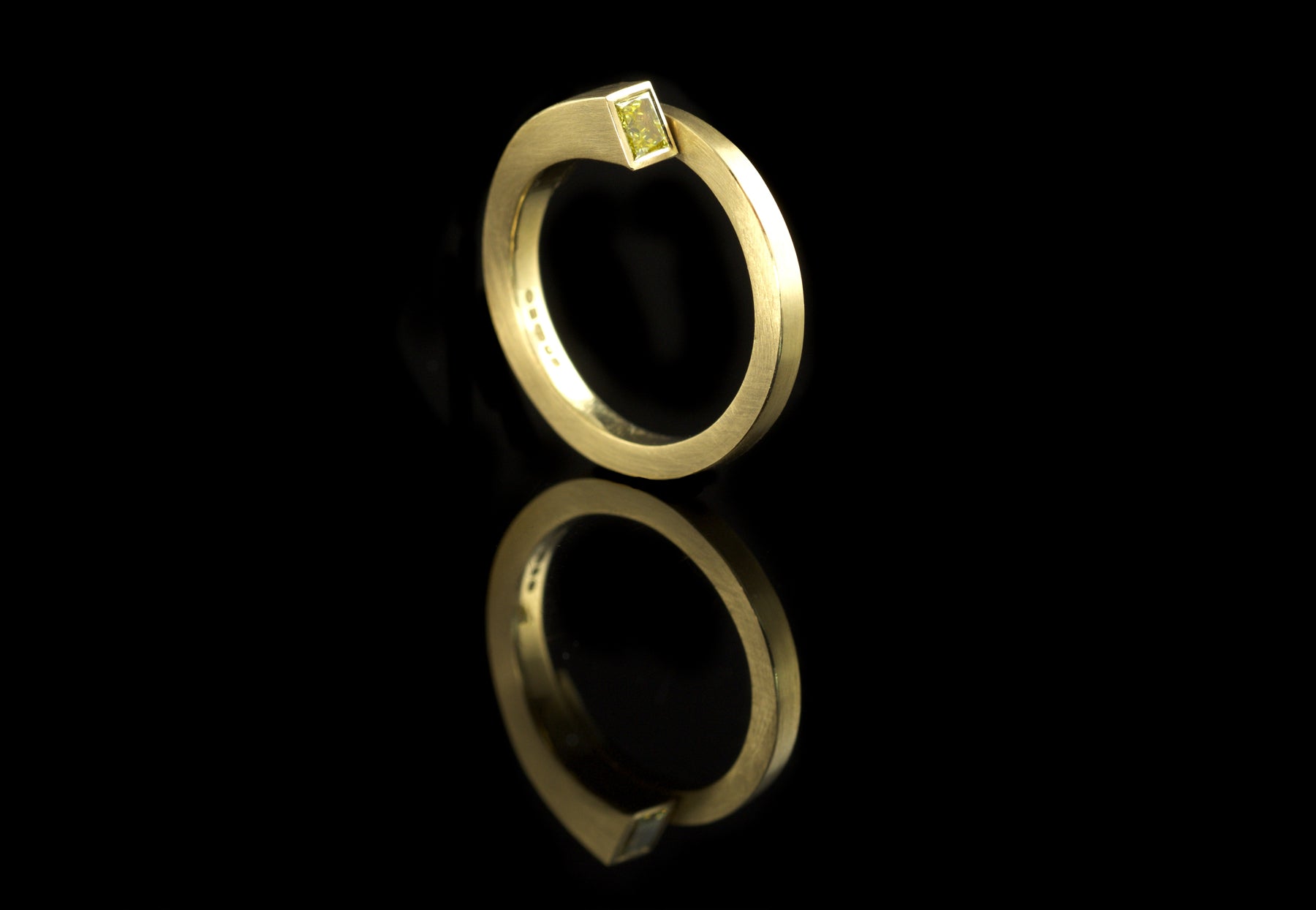Forged yellow gold overlap ring set with yellow princess cut diamond