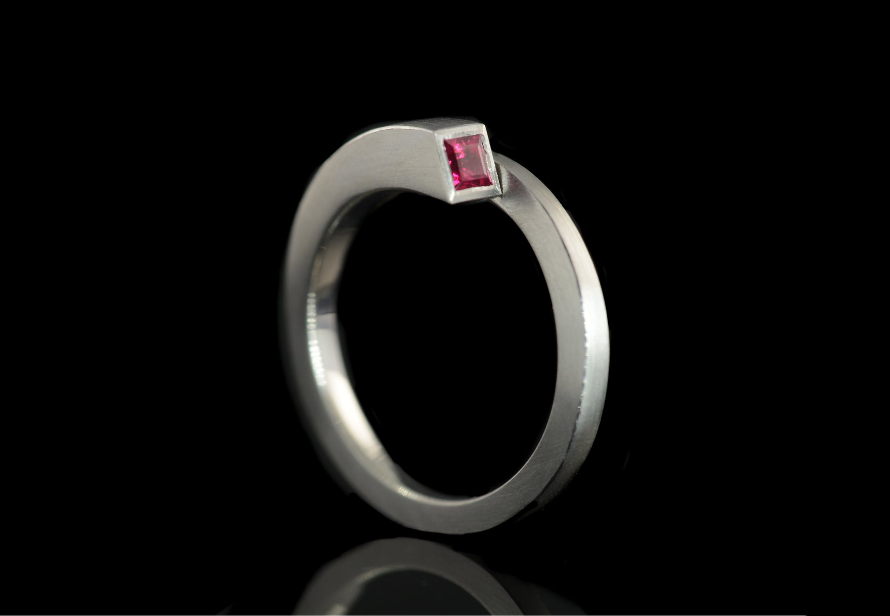 Unusual forged platinum Overlap engagement ring set with princess cut ruby