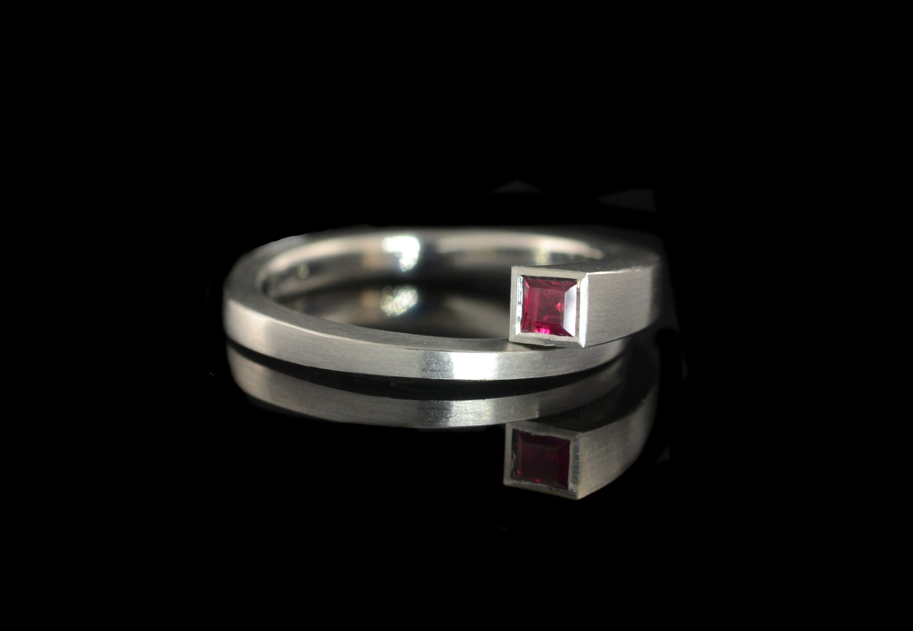 Forged platinum Overlap engagement ring set with princess cut ruby
