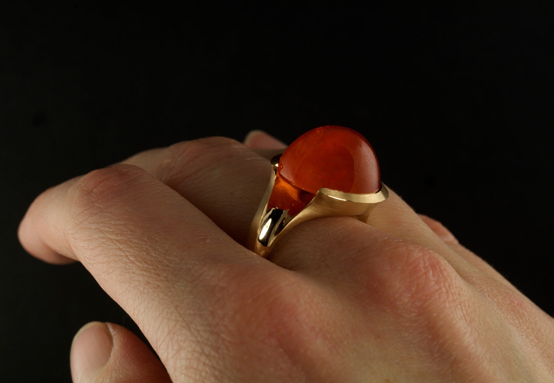 Garnet and rose gold cocktail ring on hand