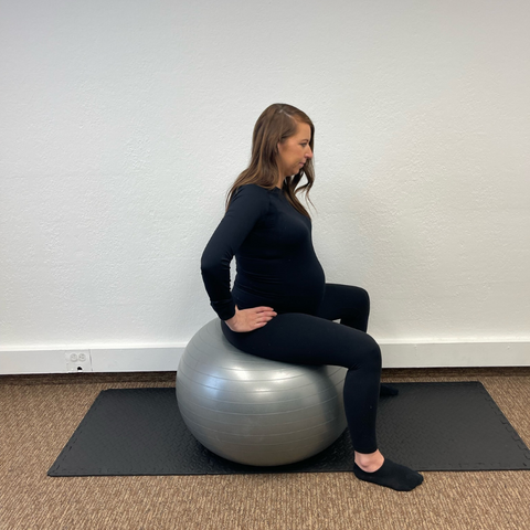 woman seated on exercise ball used for sciatic nerve pain relief