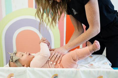 chiropractor adjusts baby with reflux