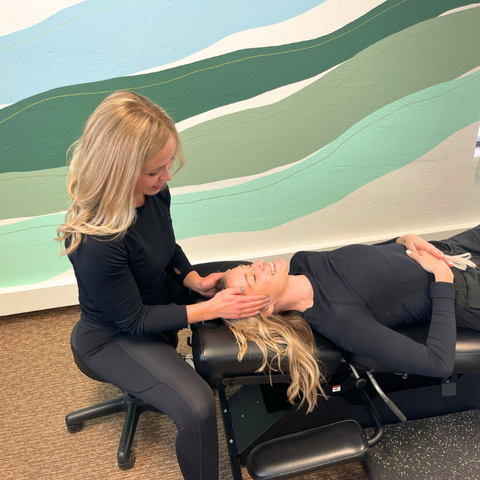 Chiropractor treating female’s jaw