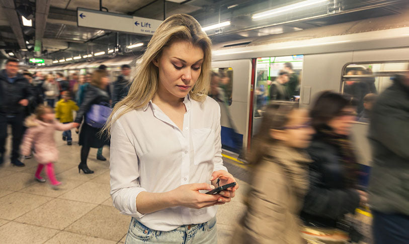 looking at phone in busy station