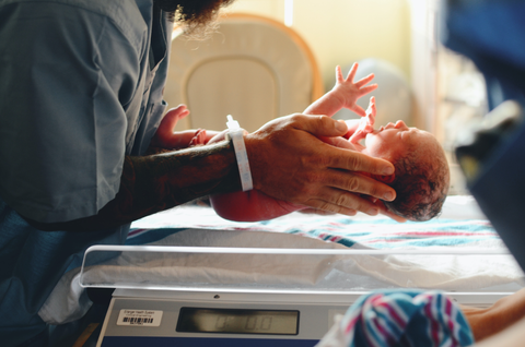 Weighing baby. Image by Christian Bowen, Unsplash