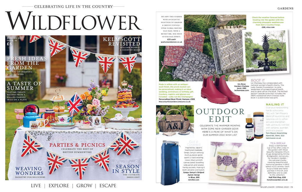 Nimi Projects' Sanpu Sanyo Japanese long canvas gardening apron in blue with striped cotton side panels, featured in a collection of gardening tools in for the Summer issue of Wildflower magazine.