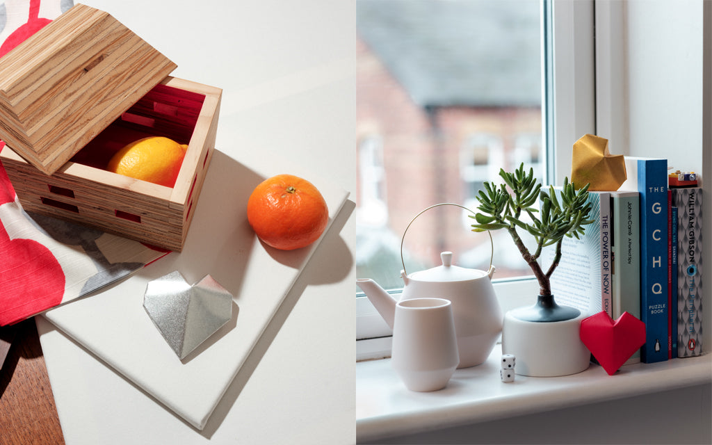 A composite image of two photographs: Left show an open recycled wood Pivoto House Box with pink interior, Right shows a pale pink Frustum Teapot with matching cups on a window sill accompanied by a Watanabe Thoki Vase. All items are handmade. Photographs shot at NiMi Projects UK. 