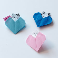 Origami heart notelets in powder blue, bright blue and pink, each with a little cat poking out the top, made for NiMi Projects origami workshops