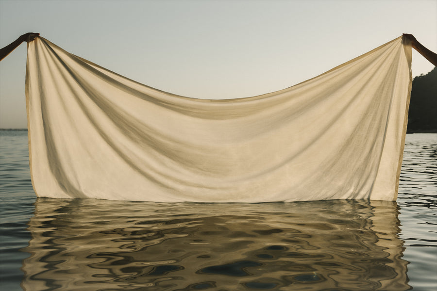 A sheet of hemp fabric being lifted our of the sea to illustrate the beauty of Majotae, a new brand of fine hemp textile made in Japan and launched at Milan Design Week 2024