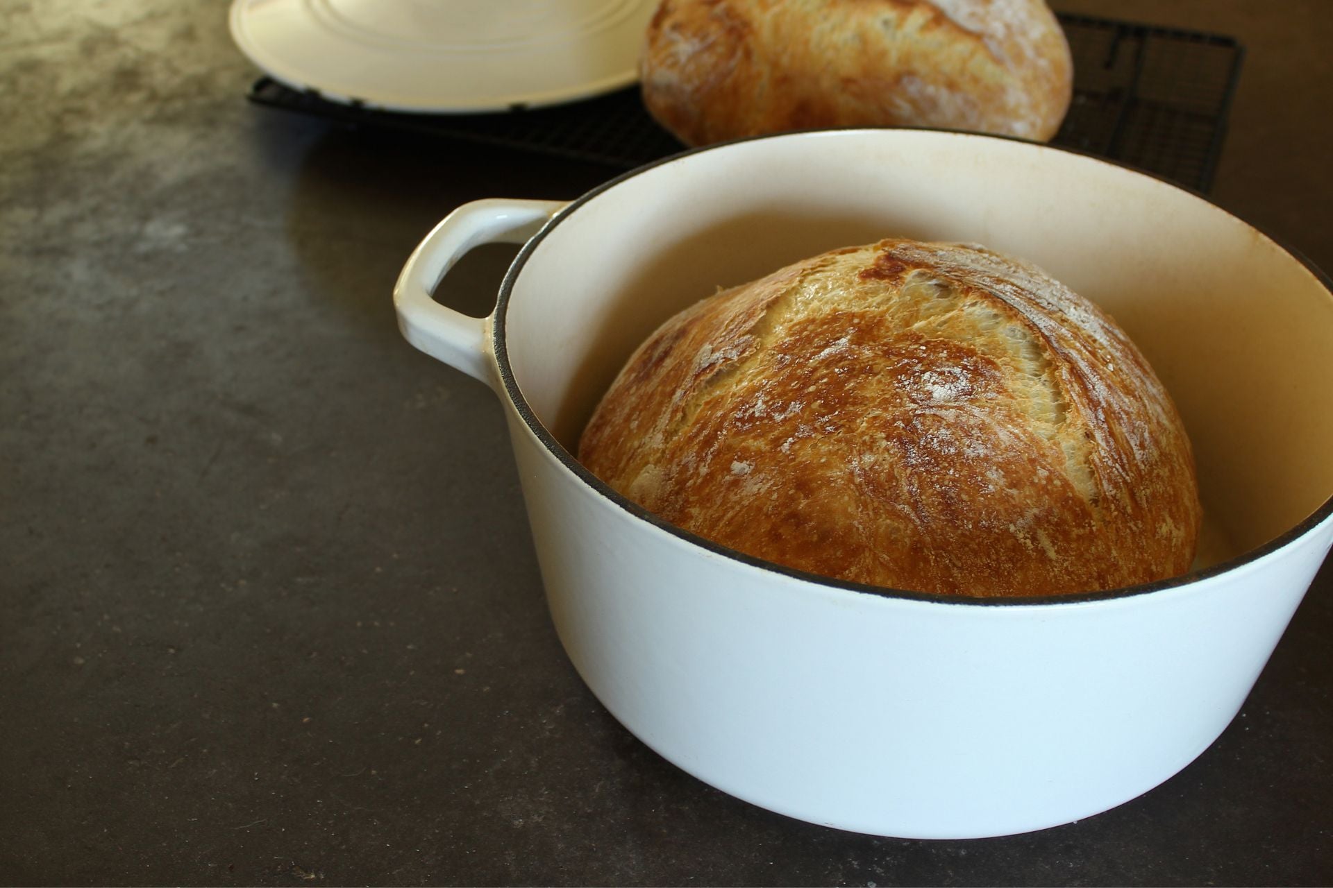 A freshly baked loaf of bread inside a Dutch oven