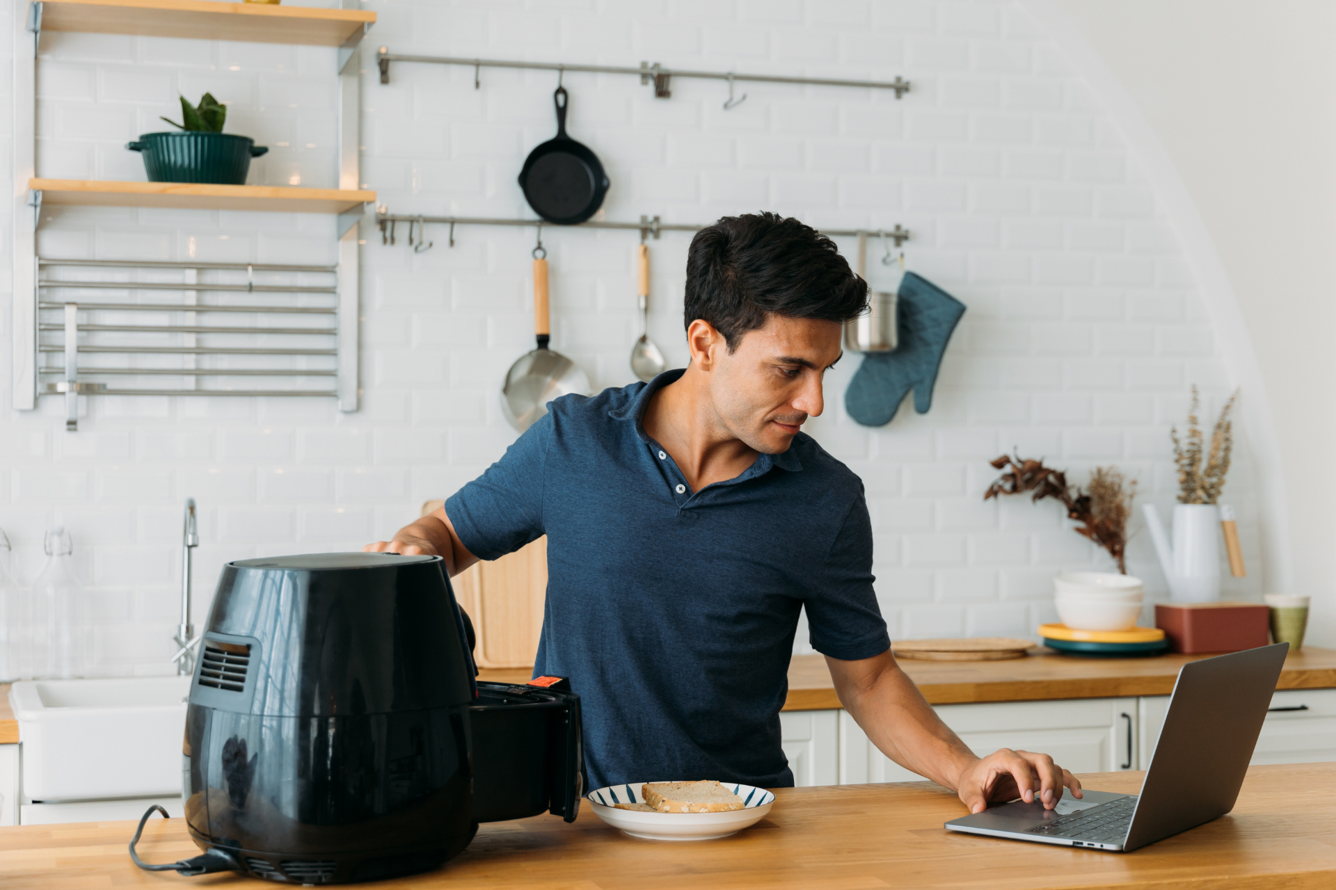 A party host looks up recipes to use in his air fryer