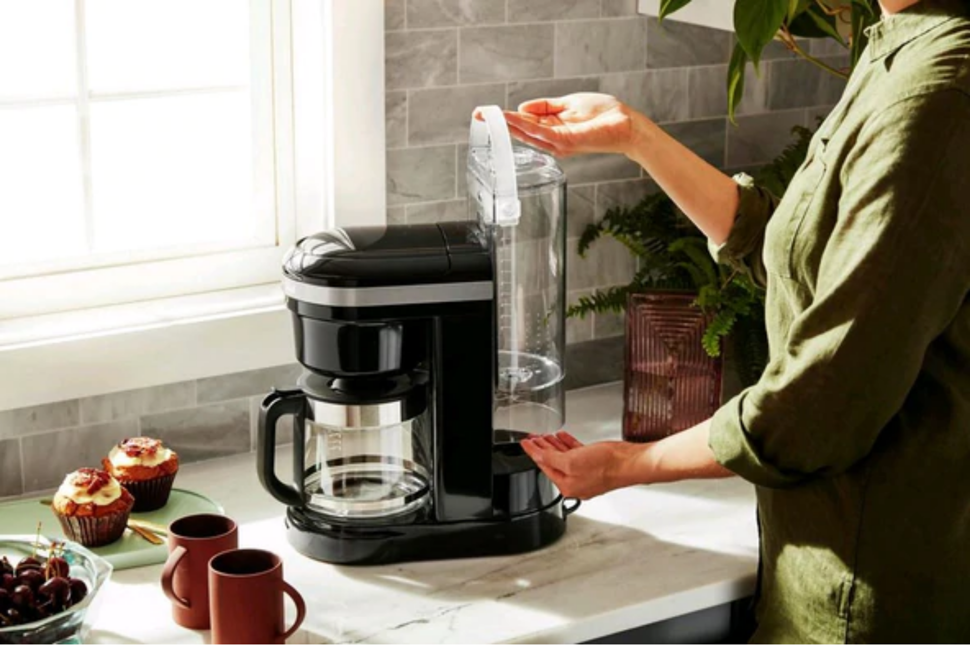 a black coffee maker on a kitchen counter