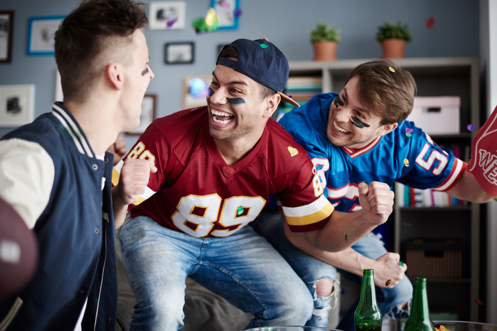 A group of friends celebrate a touchdown