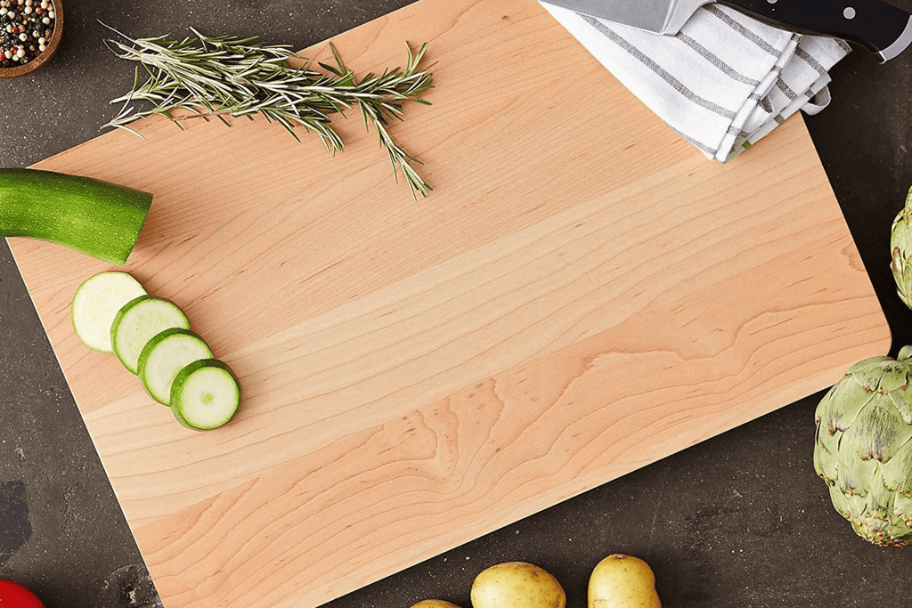 a John Boos cutting board surrounded by vegetables