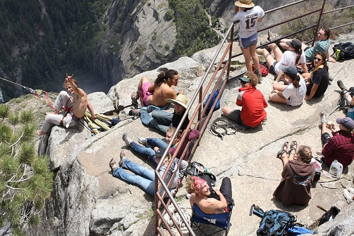 A group of slackliners at the top of Yosemite Falls