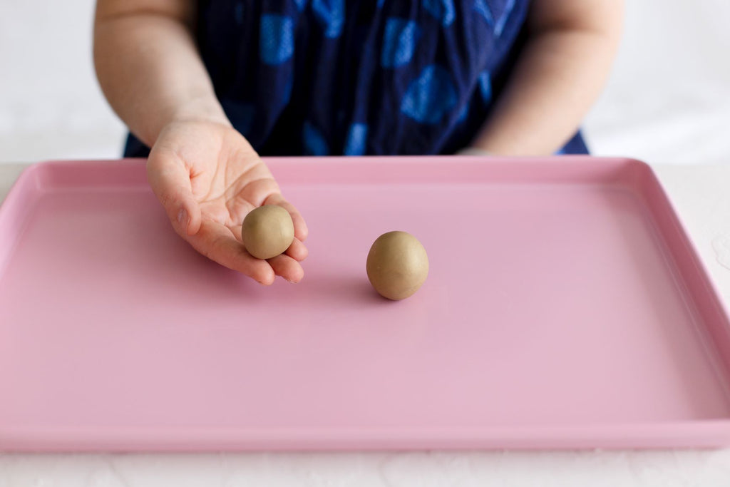 DIY baked clay dinosaur creative play fun with wooden dinosaurs in a baking tray