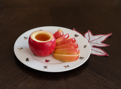 Honey crisp apple carved into a bowl with apple slices for Jewish New Year