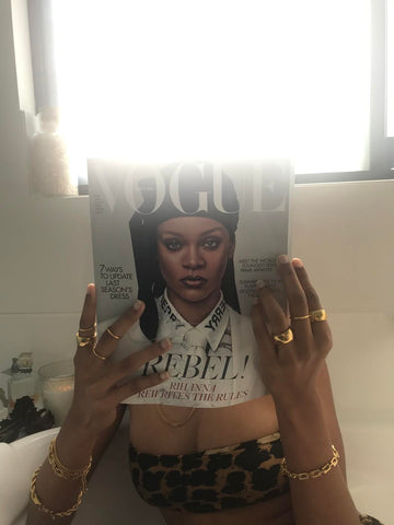 woman showing all of her jewels while reading the Vogue magazine