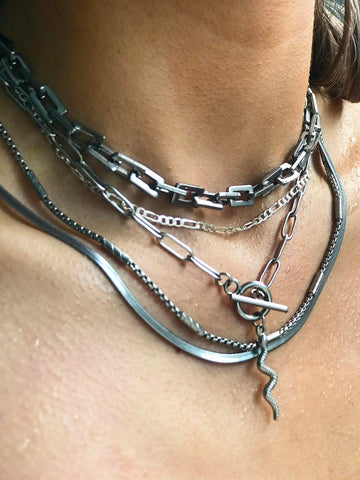 a close up in J-Line silver necklaces