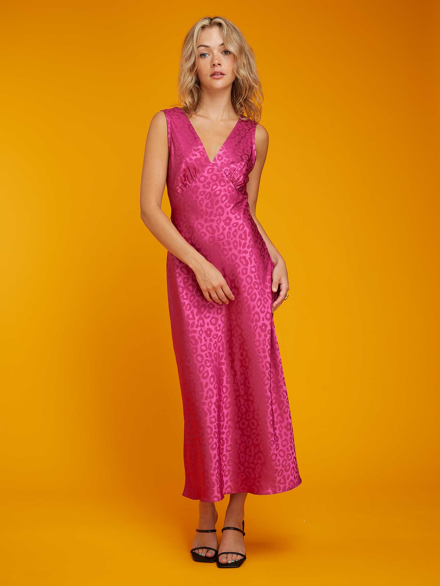 Update your wardrobe with a pleasing pop of pink. The Omnes Iris dress is ready and waiting to take you from work to weddings or any special occasions. It has a cool jacquard animal print and thick strap midi slip silhouette with a v neck.

