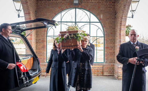 holding funeral casket