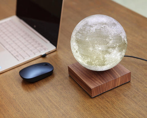 Moon-levitating-lamp-next-to-laptop