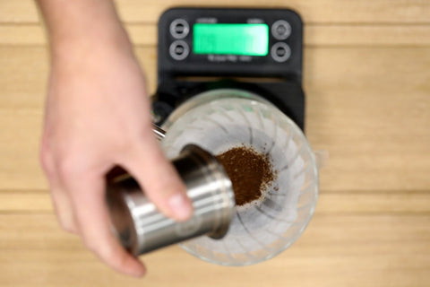 Add ground coffee to the dripper