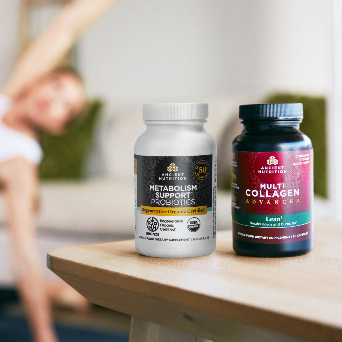 product bottles on a table with a person in the background doing yoga