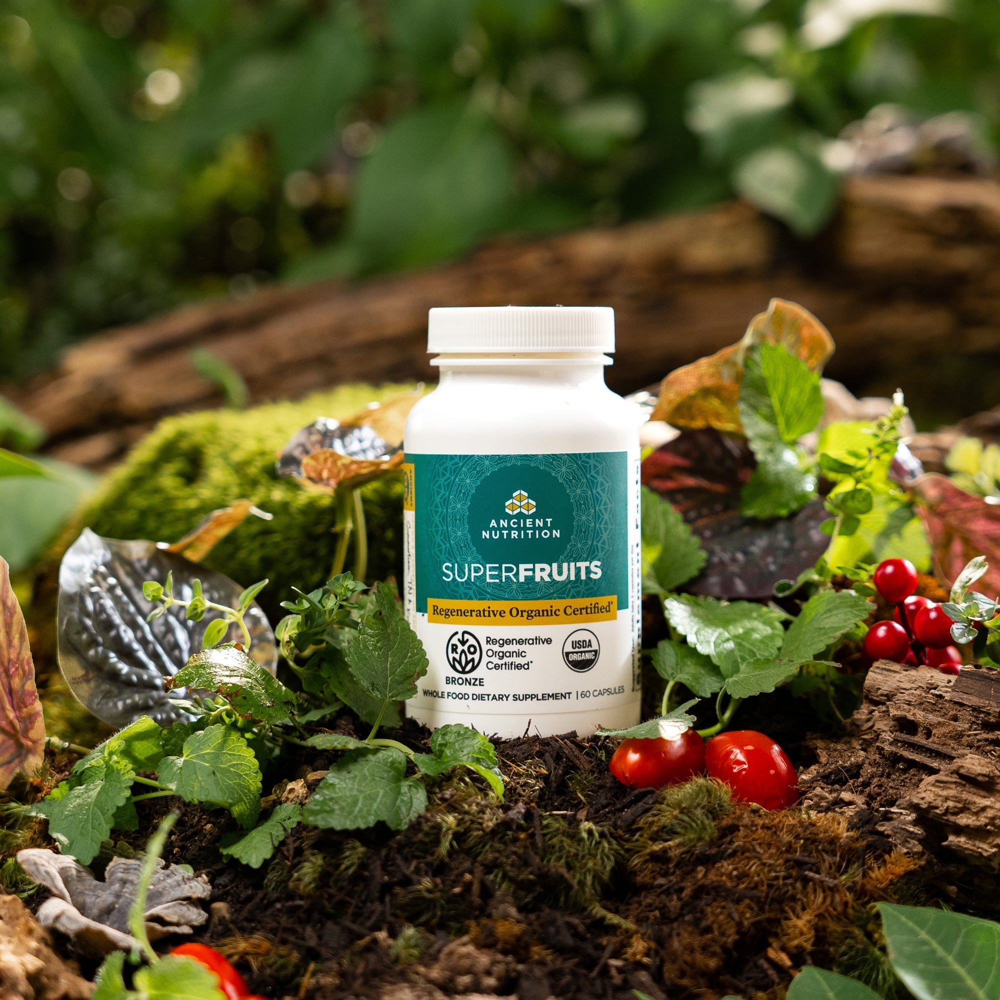 a bottle of Regenerative Organic Certified™ SuperFruits on a mossy rock