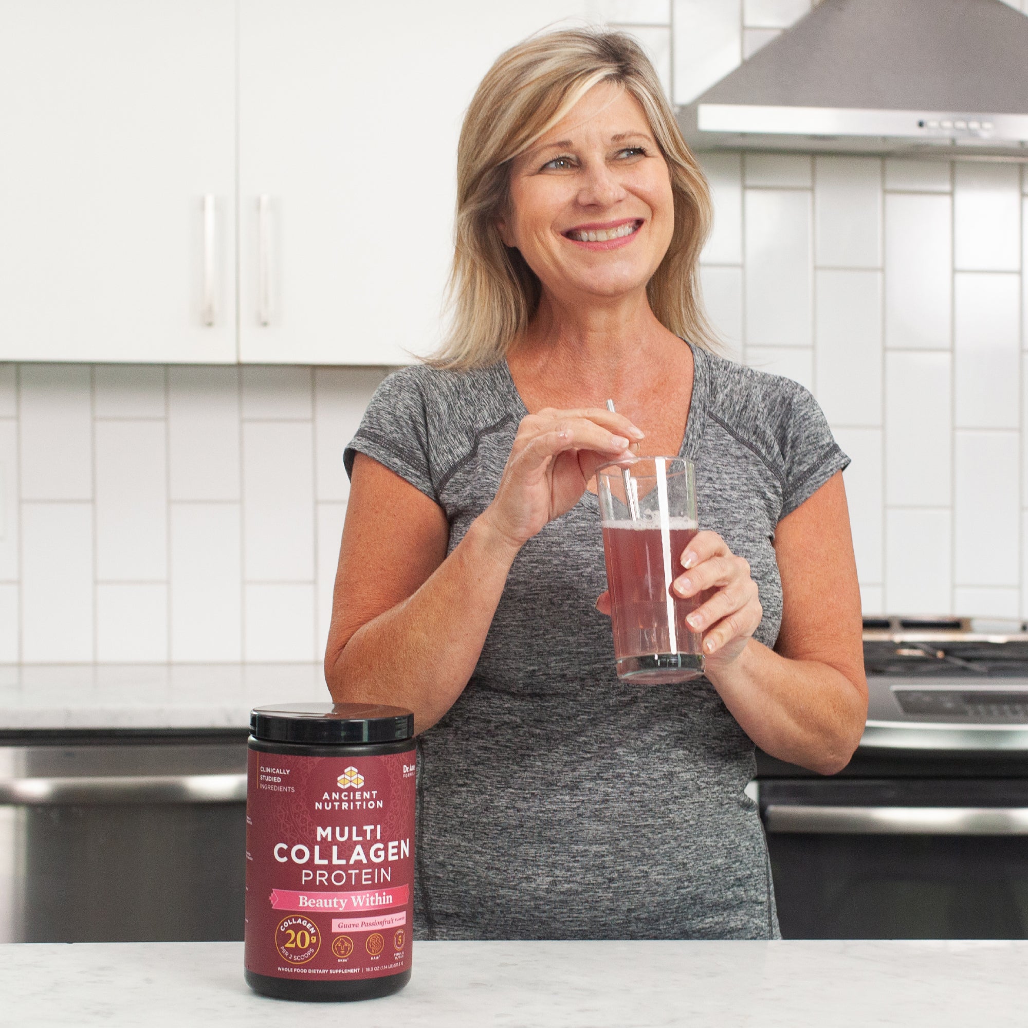 woman drinking a glass of multi collagen protein beauty within 24 servings 