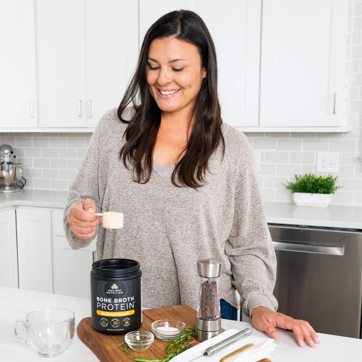 woman scooping bone broth protein butternut squash