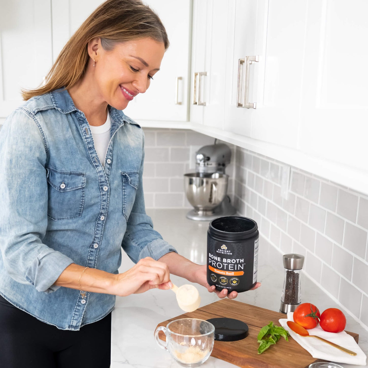 woman scooping bone broth protein tomato basil