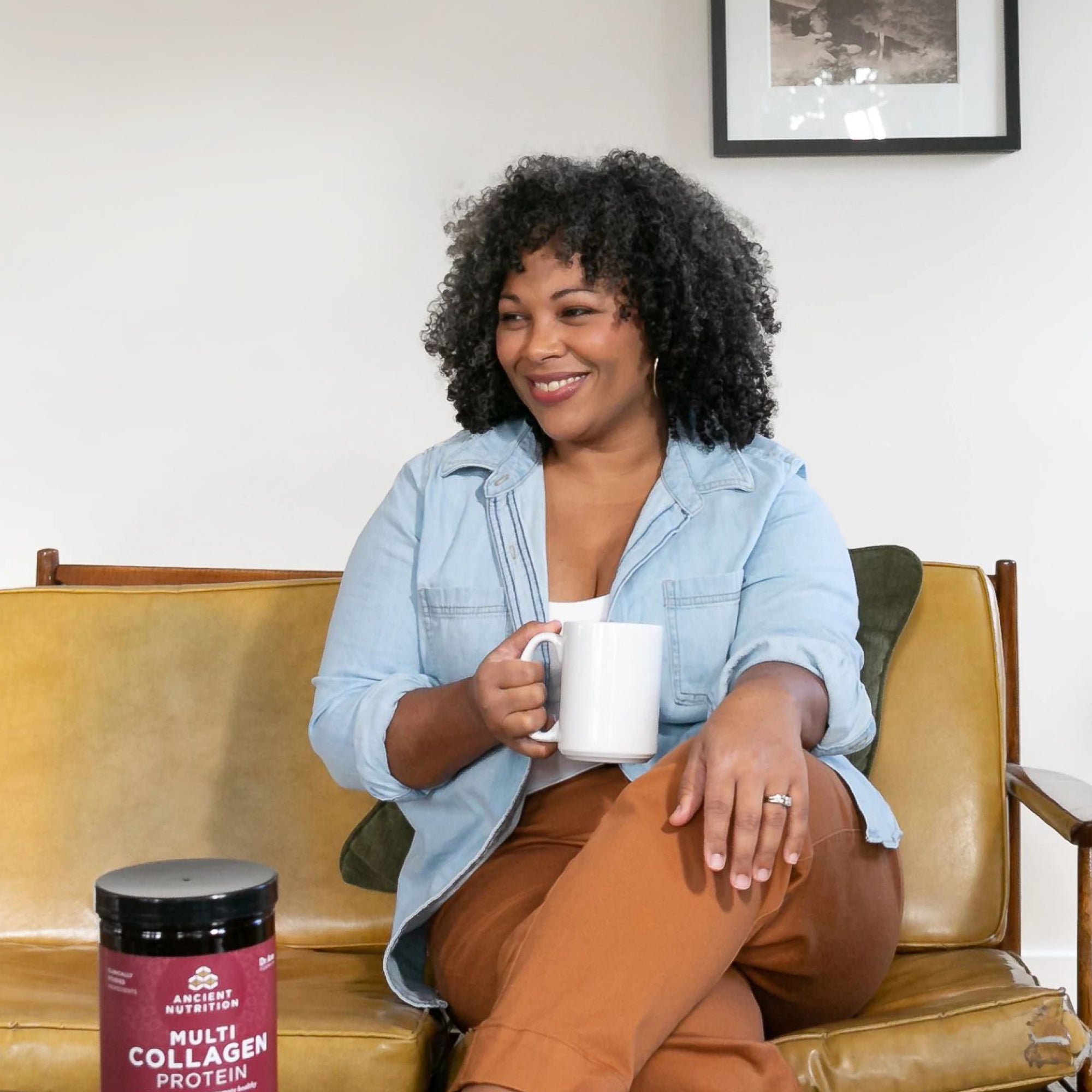 women with coffee cup on couch