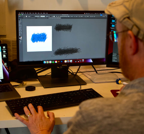 A MFG Merch designer working on the scribbles within artwork created by a child.