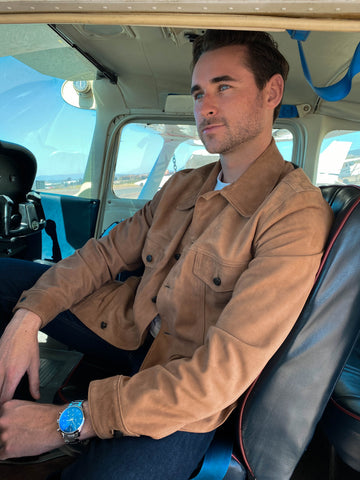 Pilot Ryan in his one engine plane wearing Cockpit USA's Suede Trucker Jacket