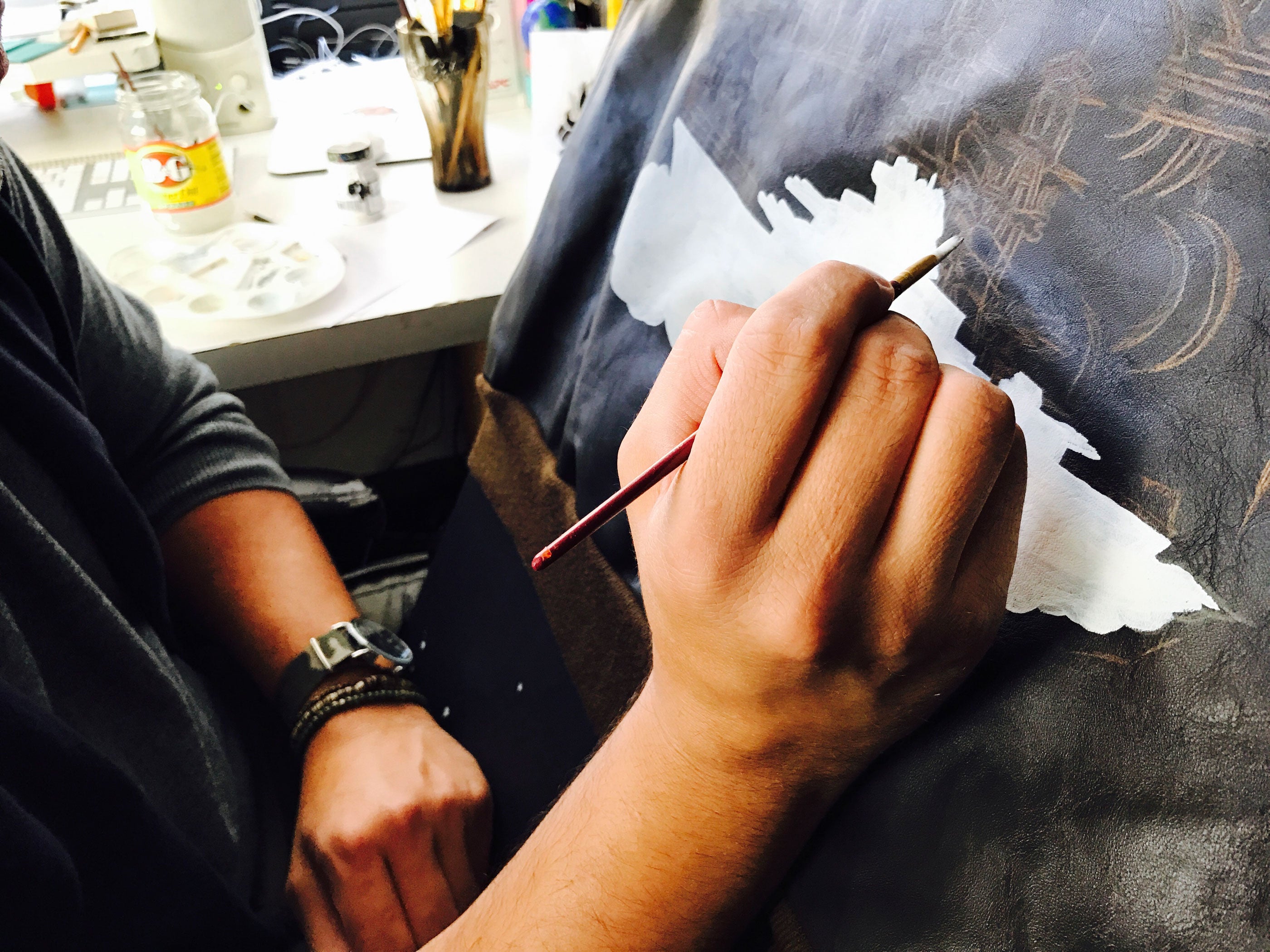 Hand painting the back of our horsehide A-2.
