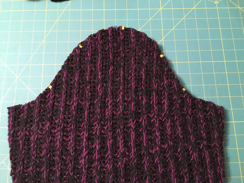 Use of draping tape to mark sleeve on bulky sweater knit