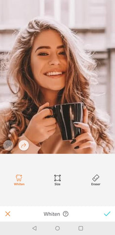 woman smiling with a cup of coffee