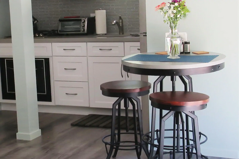 table with flowers and two stools
