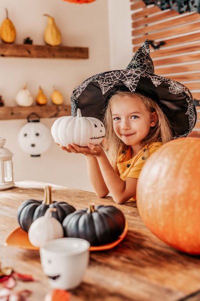little girl with white pumpkin 