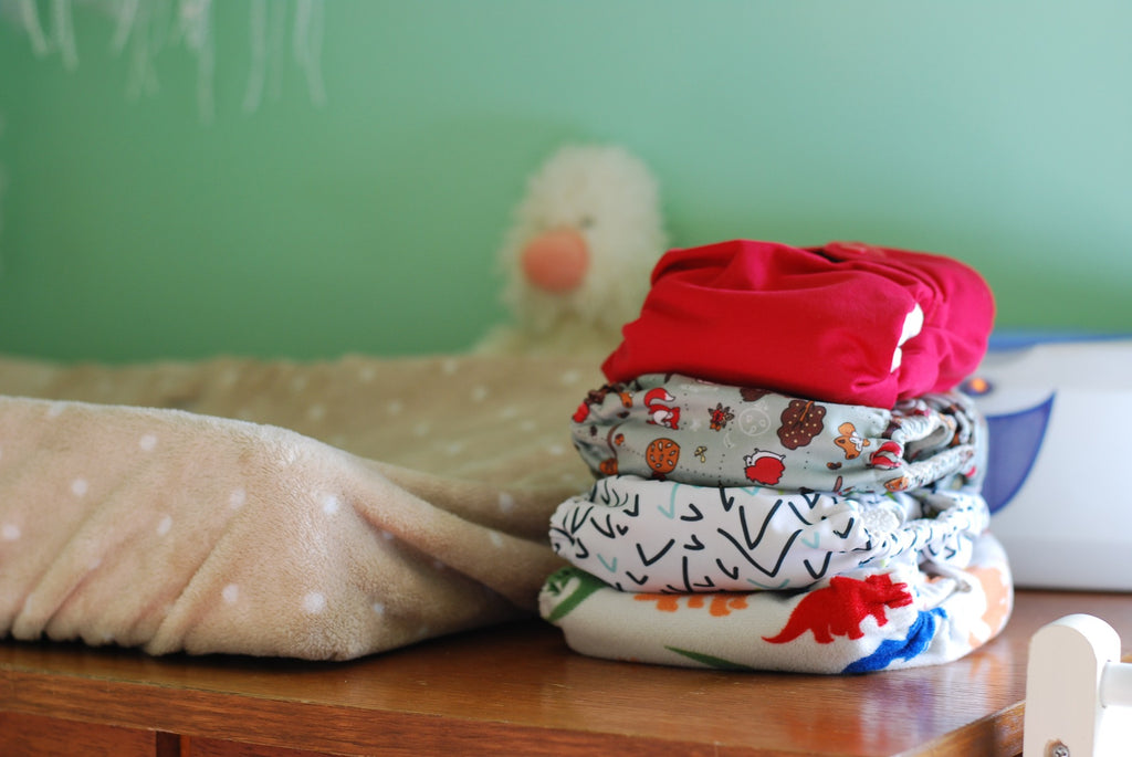 Cloth diapers beside a change table