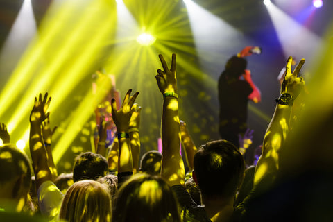 silhouette of hands up at the rap concert