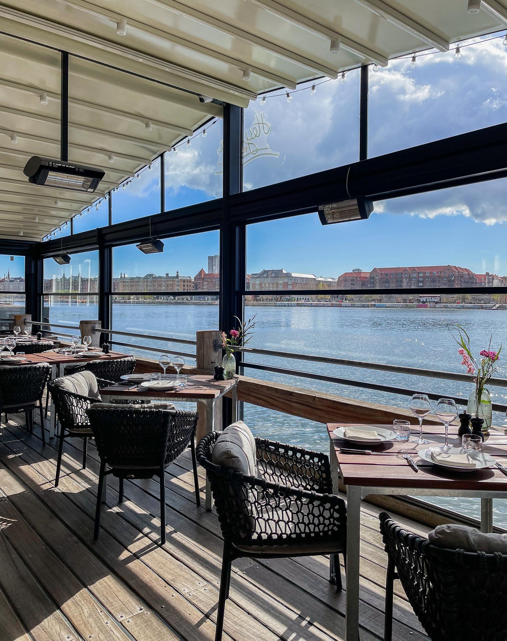 Dining setting with beautiful sea view over Kalvebod Brygge in Copenhagen, Ocean dining chairs lava grey, glass all around the restaurant